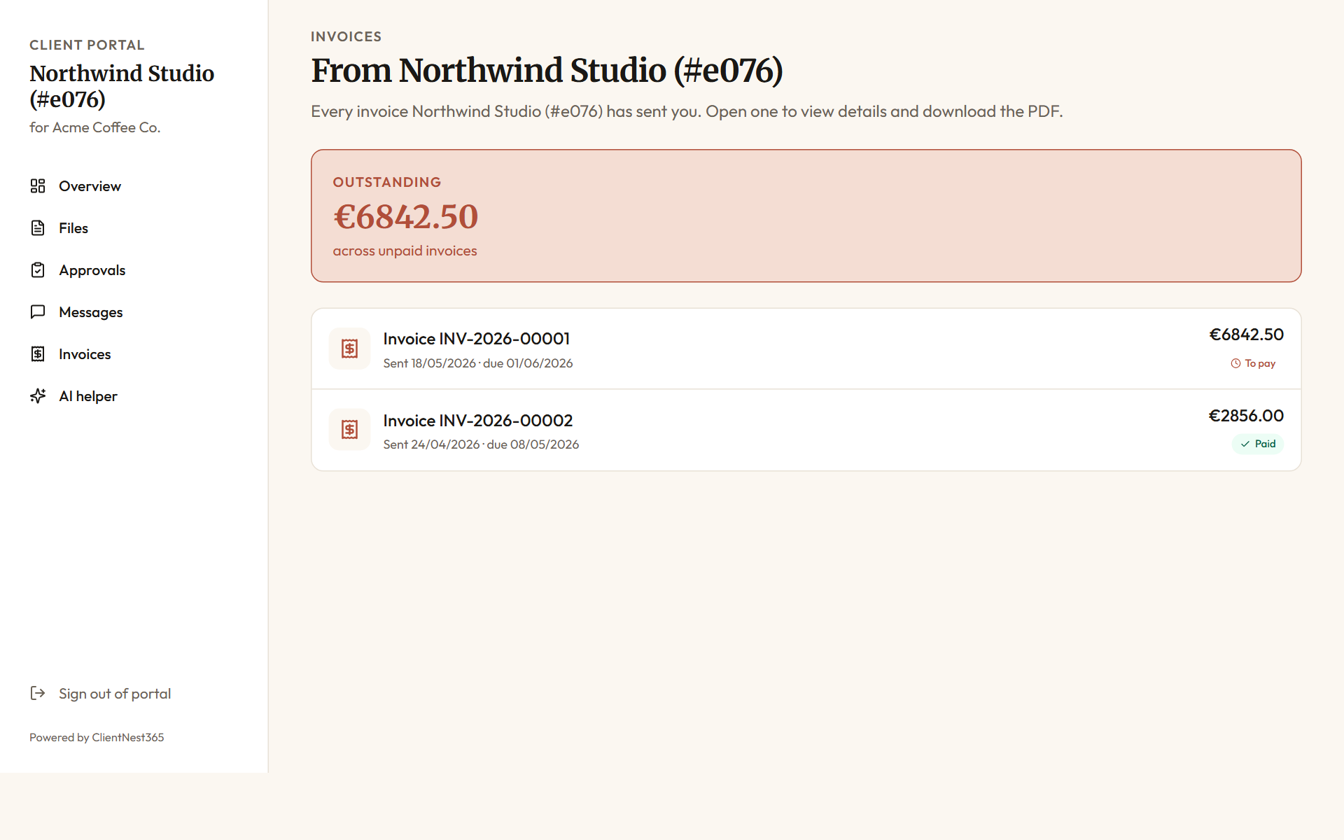 Client portal invoices view: the client sees both an outstanding invoice awaiting payment and a previously paid invoice, with status badges